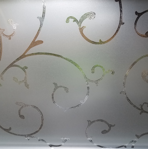 Close-up of a decorative frosted glass pattern with swirling designs.