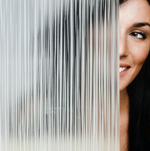 Smiling woman partially obscured by a translucent textured surface.